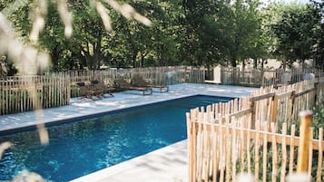 Seasonal outdoor pool, open 9:00 AM to 9:00 PM, pool umbrellas