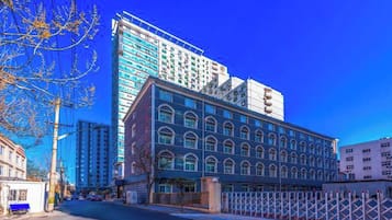A multi-story building with a modern glass facade and a classic architectural style.