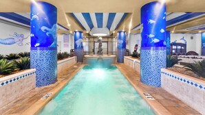 A pool area with a central fountain, surrounded by columns with mosaic tiles and murals of sea creatures. - Coral Beach 1022-Oceanfront 1BR-Pools-Lazy River (Myrtle Beach)