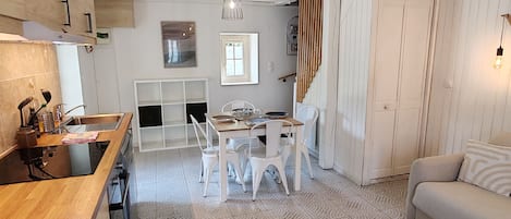 A spacious living area with a kitchen, dining table, and seating.