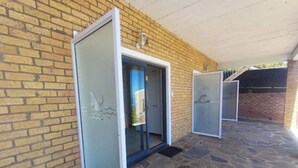 A building with a brick exterior and a stone patio. - Cloud 9 Room 6 King Bed & Stunning Views (Cape Town)