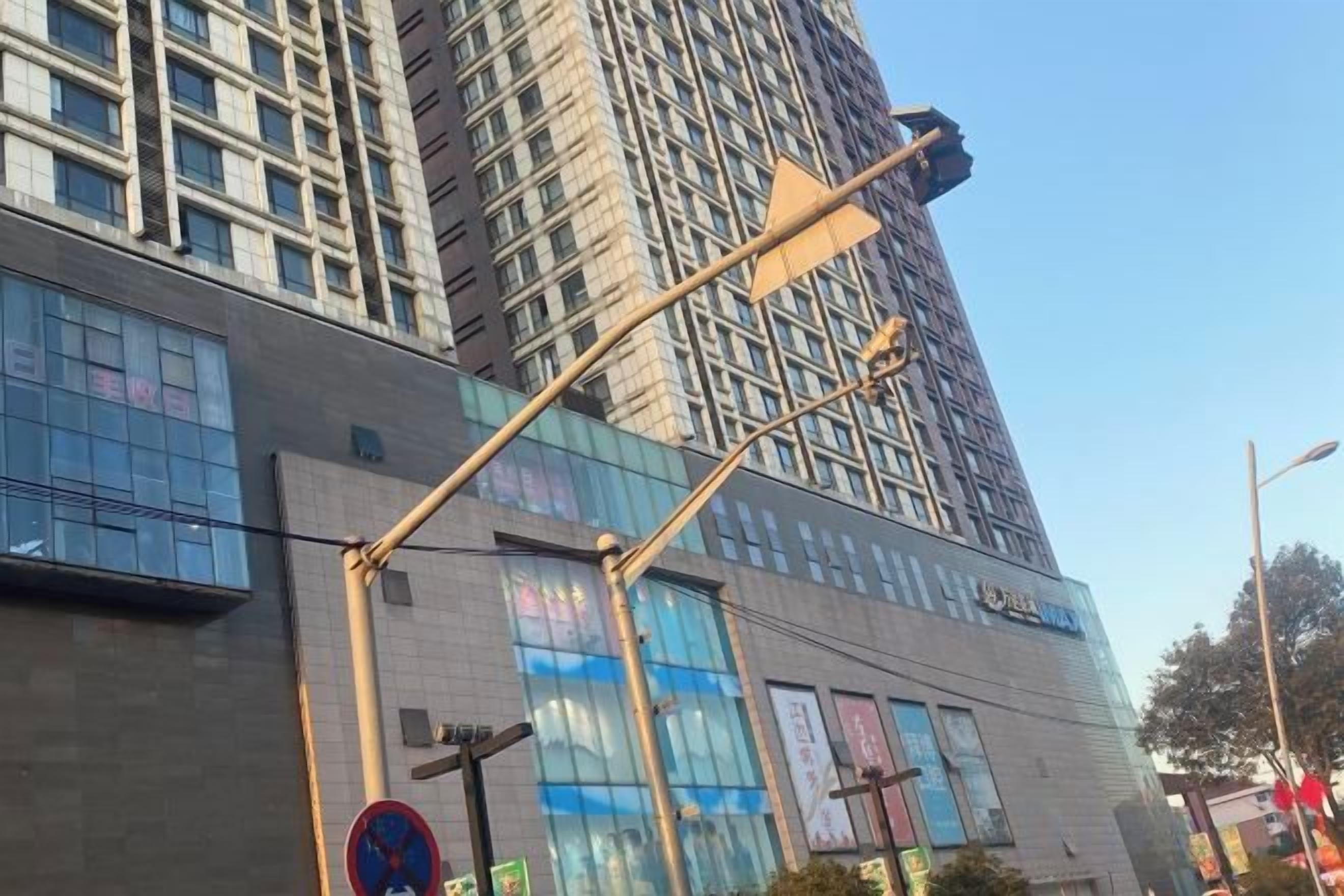 A modern building with large windows and a street lamp.