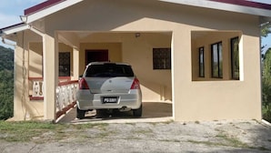 A single-story building with a car parked in front. - Room-near air and Ferry Ports, Shops & b (Castries)