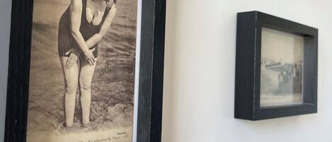 A wall with multiple black-framed photographs.