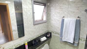 Shower, hair dryer, towels, toilet paper