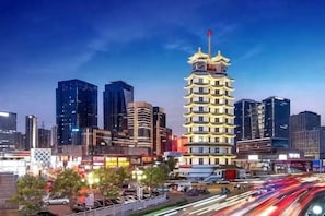 A cityscape with modern buildings and a traditional pagoda-style structure. - Future Yiju Shanghui Hotel (Zhengzhou Manhadun Yanzhuang Metro Station) (Zhengzhou)