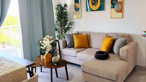 Una sala de estar moderna con sofá, mesa de centro y comedor.