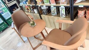 A seating area with two chairs and a small round table, likely in a cafe or restaurant setting. - Keyuan hotel (Beijing)