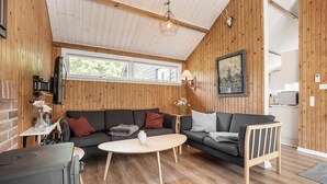 A cozy living room with a wooden interior, a sofa set, a coffee table, and a fireplace. - Amazing home in Tarm with WiFi (Tarm)