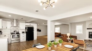 A modern apartment with a kitchen, dining area, and living room.
