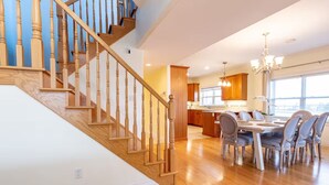 A spacious kitchen with wooden cabinets and a dining area with a table and chairs. - The Perfect Brule Shore Getaway (Brule Shore)