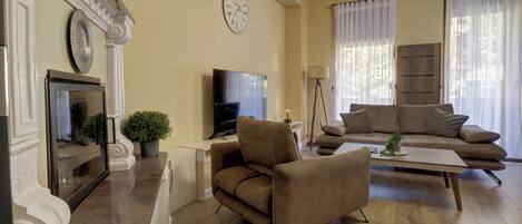 Suite, 1 King Bed with Sofa bed, Balcony | Living area | Smart TV