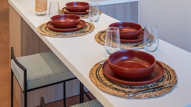 A modern kitchen with a white countertop, a microwave, a toaster, and a coffee maker. - Emma's Central Suite (Kos)