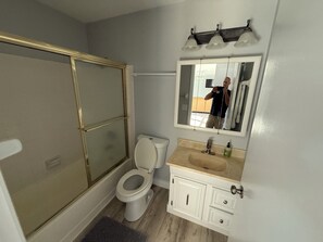 A bathroom with a shower, toilet, sink, and vanity. - Great rental close to all the fun! (Port Charlotte)