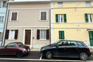 Una hilera de edificios de tres pisos con estilos arquitectónicos diferentes y diseños de ventanas variados.