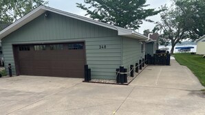 A single-story building with a garage, numbered 348, and a paved driveway.