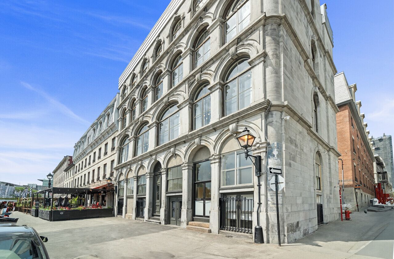 A historic building with large arched windows and a corner entrance.