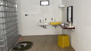 A modern bathroom with two sinks, a mirror, and a glass partition. - Lafite Apple B&B (Hangzhou)