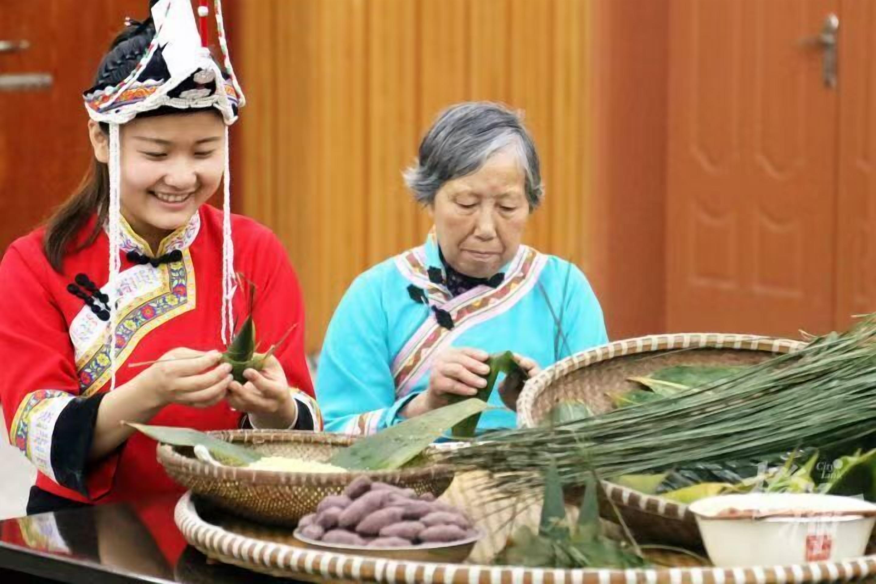 Two individuals seated at a table with traditional items and a woven basket.