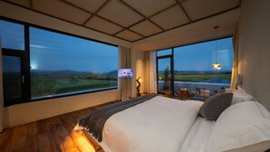 A bedroom with a large bed, a view of the countryside, and a modern ceiling design. - LOST VILLA-ff (Deqin)