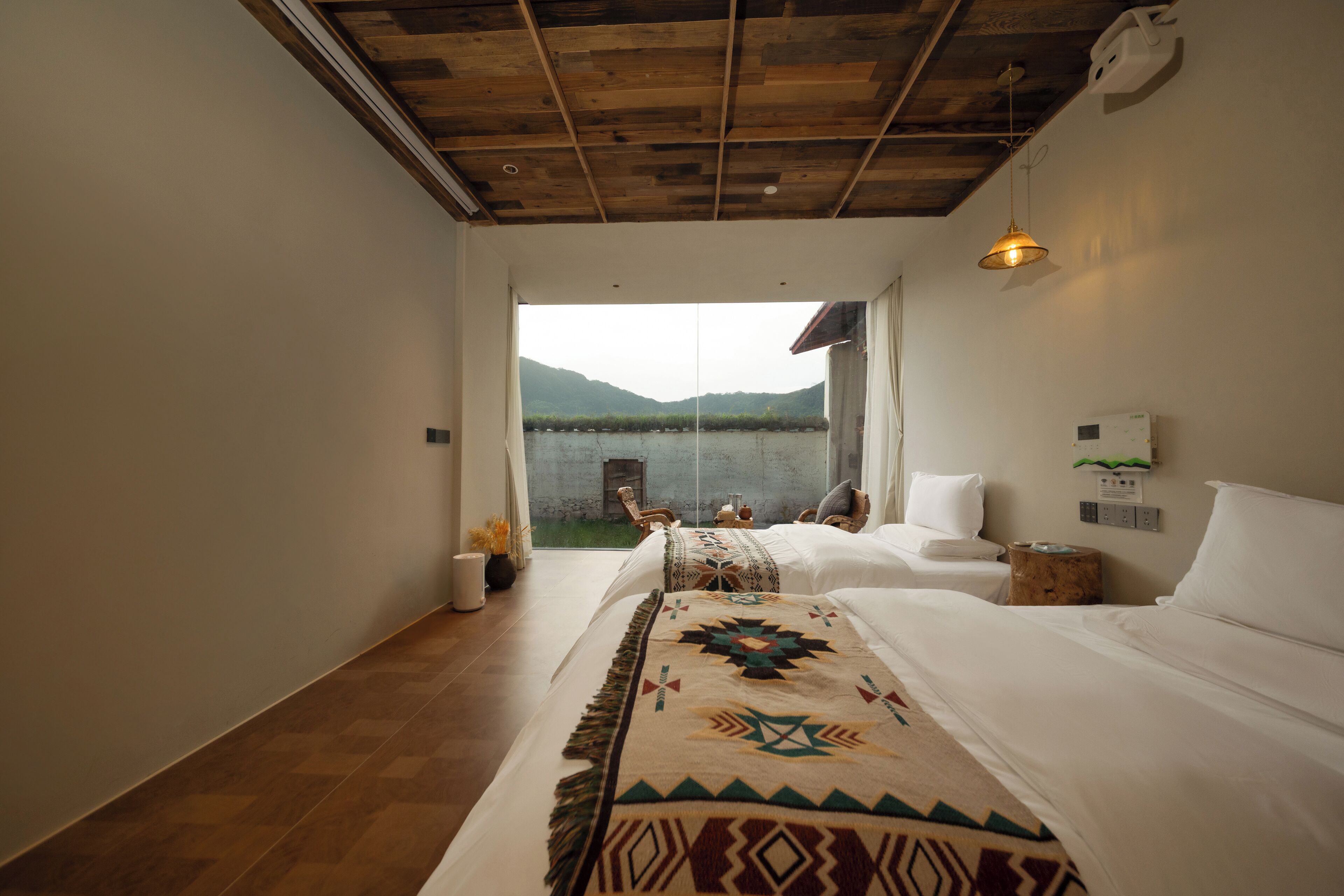 Un dormitorio con una cama grande, vistas a un lago y techo de madera.