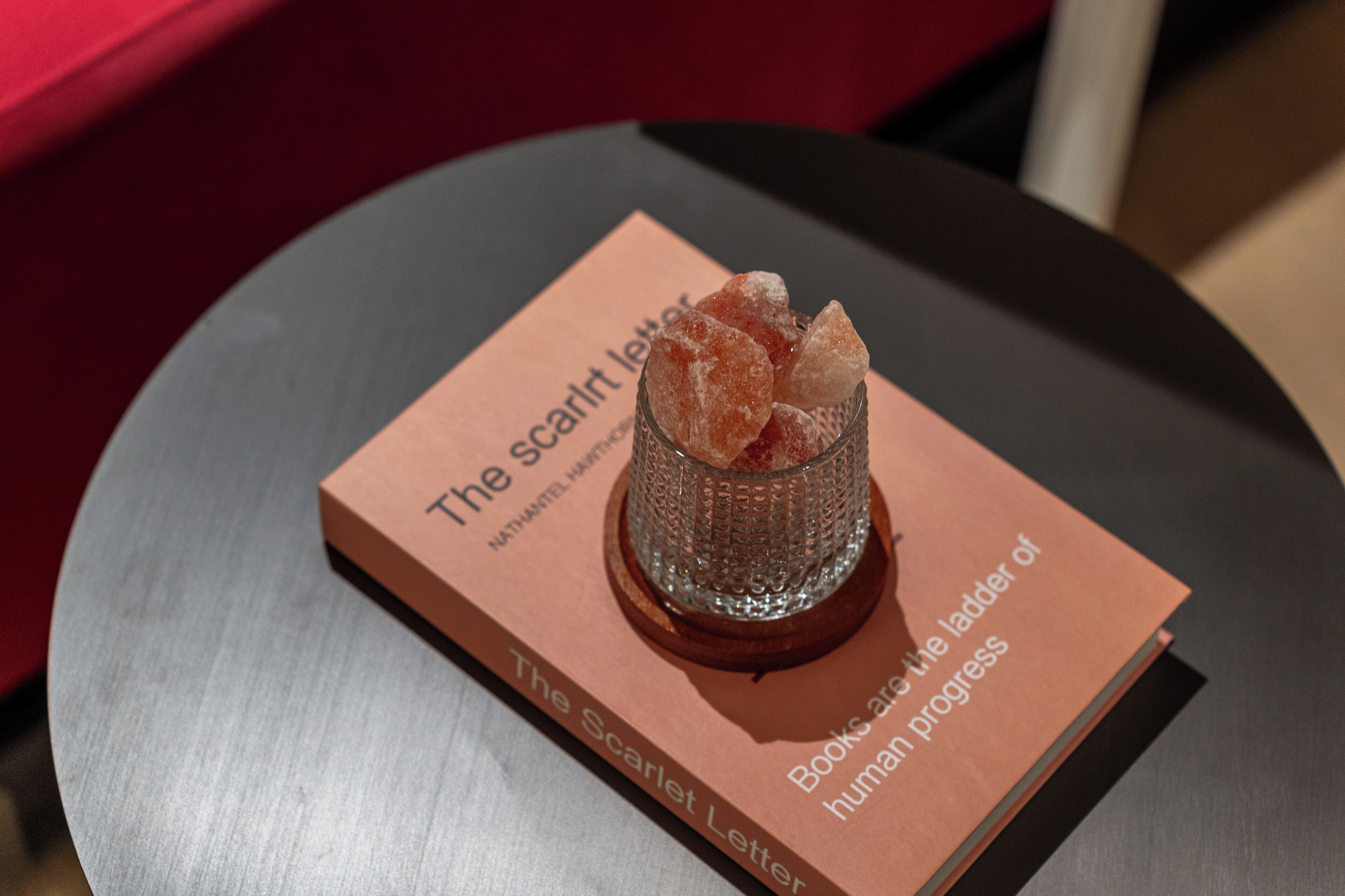 A book titled "The Scarlet Letter" by Nathaniel Hawthorne on a table.