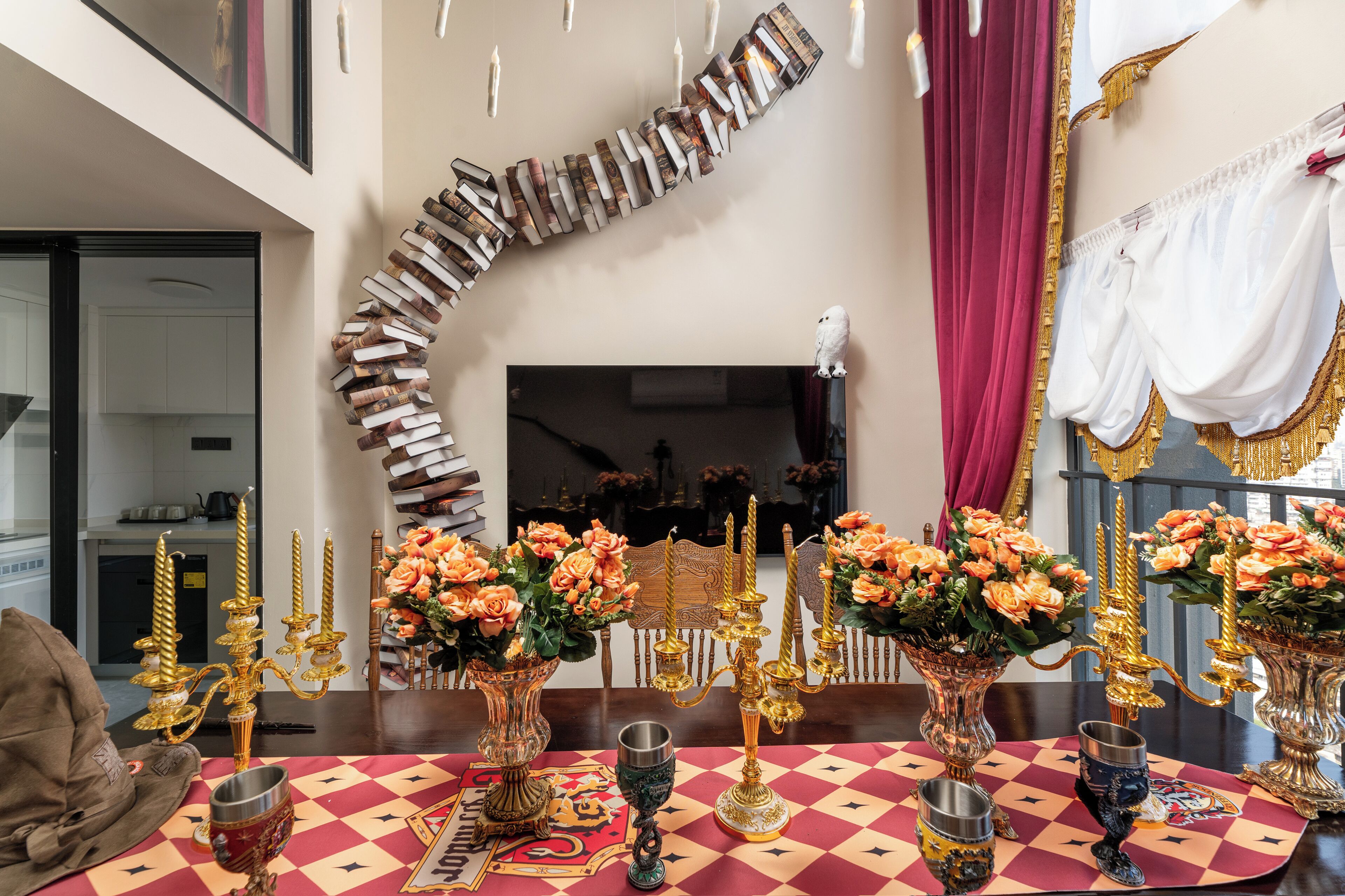 Een eethoek met een geruit tafelkleed, gouden kandelaars en bloemrijke decoraties.