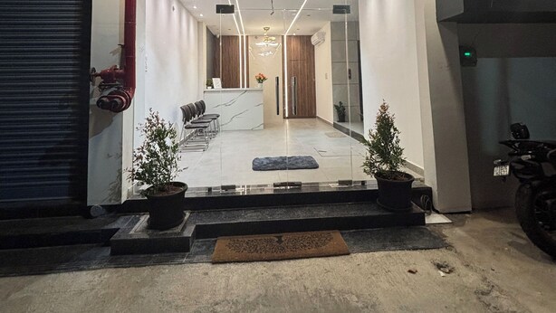The entrance of Hotel Mithra Grand with a reception desk, seating area, and potted plants. - HOTEL MITHRA GRAND (Hyderabad)