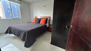 A bedroom with a bed, a nightstand, and a window. - Charming 2-bedroom apartment in enchanting Bogotá with WiFi (Bogotá)