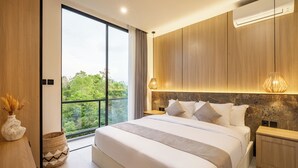 A modern bedroom with a large bed, wooden paneling, a view of greenery, and a balcony. - Tropical Villa 8A - 8 Min Melasti Beach (Ungasan)