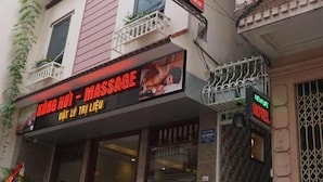 A building with a sign for 'New Life Hotel' and a massage parlor.