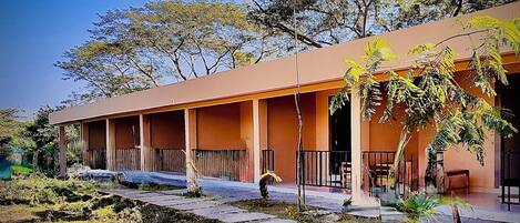 A building with a covered outdoor area, columns, and a pathway.