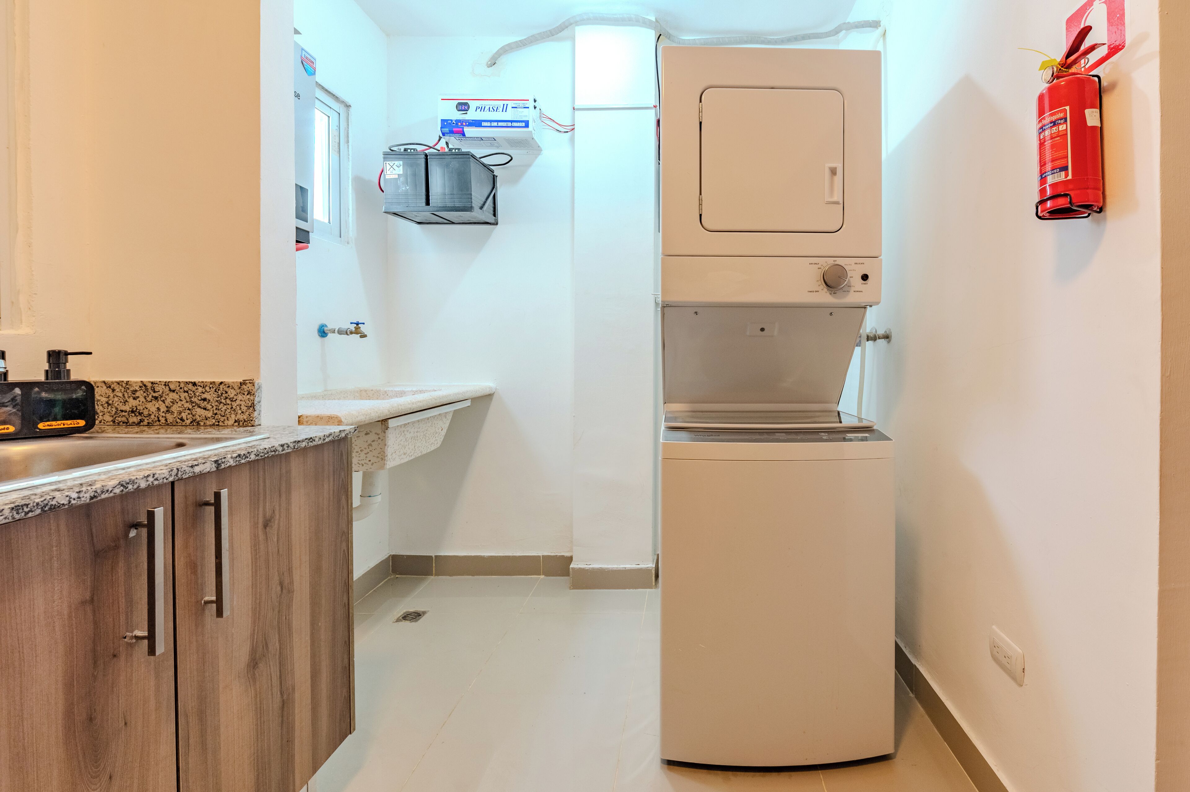 A compact kitchen with a built-in refrigerator, a sink, and a small countertop.