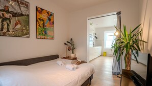 A hotel room with a bed, a desk, a mirror, and a potted plant. - Sea of Tranquility with terrace by Interhome (Oostende)