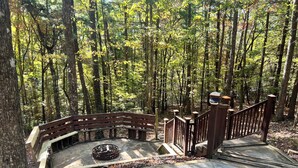 A stone staircase leading to a wooden deck surrounded by a forest. - Experience Serenity at Triple Nickel Cabin! (Blue Ridge)