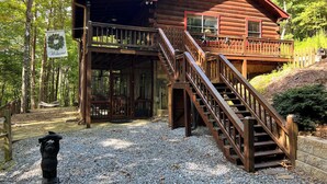 A log cabin with a wooden deck, a staircase, and a 'Welcome' sign. - Experience Serenity at Triple Nickel Cabin! (Blue Ridge)
