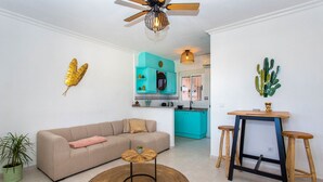 A living room with a sofa, a coffee table, a round rug, and a ceiling fan. - CH Sierra de Gata La Marquesa Golf (Ciudad Quesada) (Ciudad Quesada)
