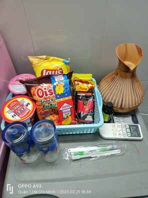 Una encimera de baño con distintos artículos de aseo y aperitivos.