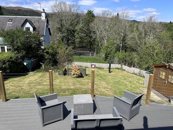 A patio with outdoor furniture, a fenced yard, and a house in the background.