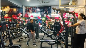 A gym with various exercise equipment, including treadmills and weight machines. - Tulip Residency (Gurugram)