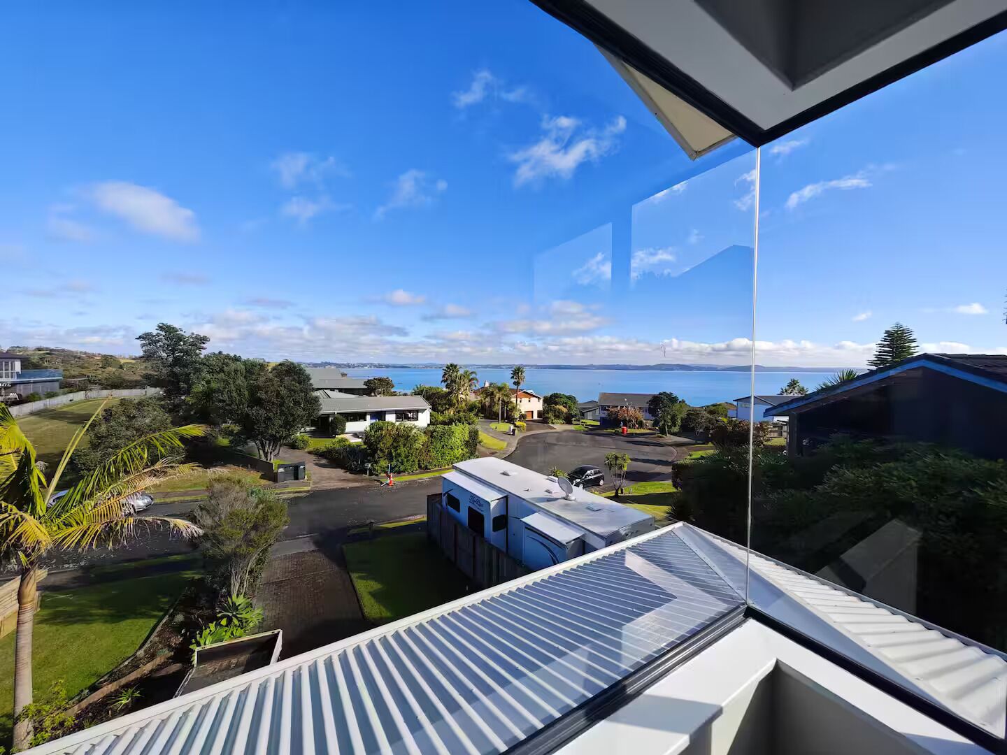 A residential area with a view of the sea and hills.