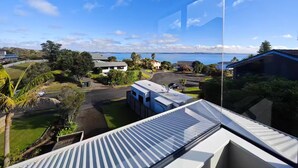 A residential area with a view of the sea and hills.
