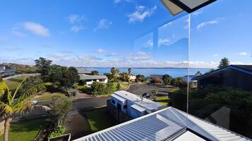 A residential area with a view of the sea and hills.