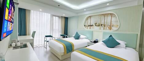 A hotel room with two beds, a desk, a TV, and a window with curtains.