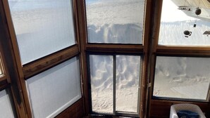 A room with large windows offering a view of a snowy landscape.