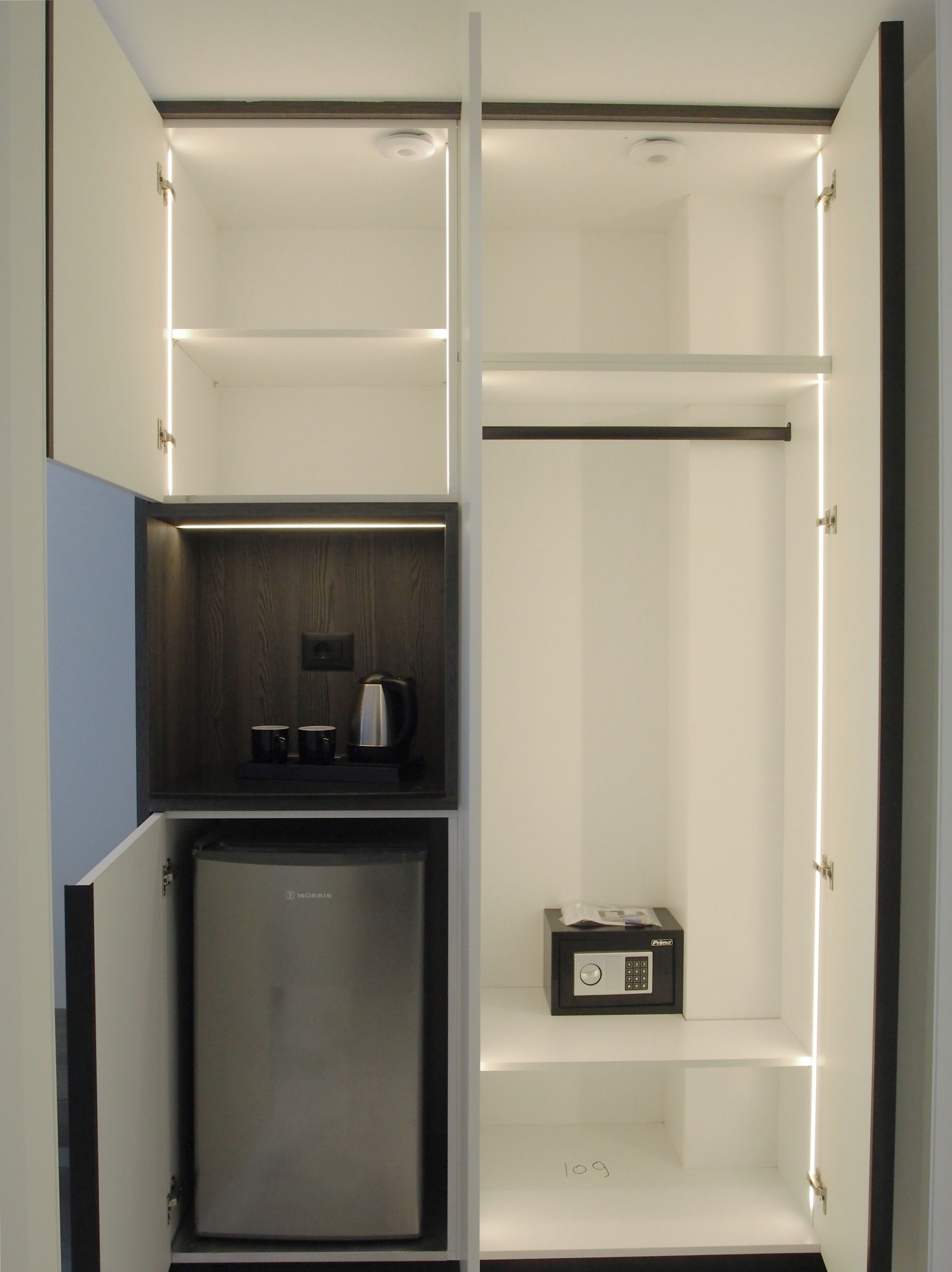 A modern kitchen with built-in appliances, a coffee maker, and a radio.
