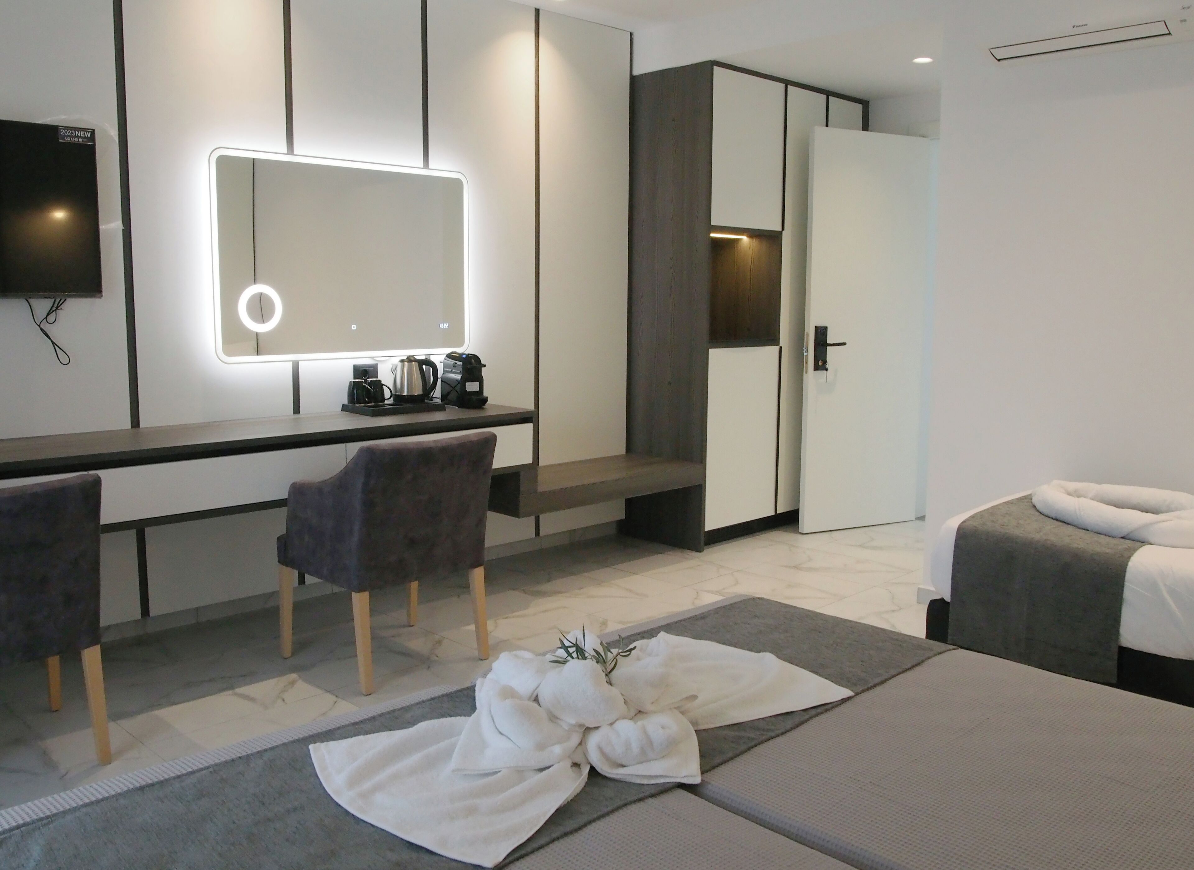 Deluxe Triple Room, Balcony | Living area | 24-inch Smart TV with satellite channels