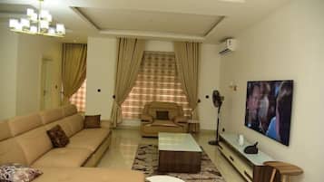 Luxury Apartment, Balcony, City View | Living area | Flat-screen TV