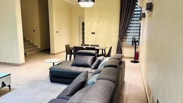 Luxury Apartment, Balcony, City View | Living area | Flat-screen TV