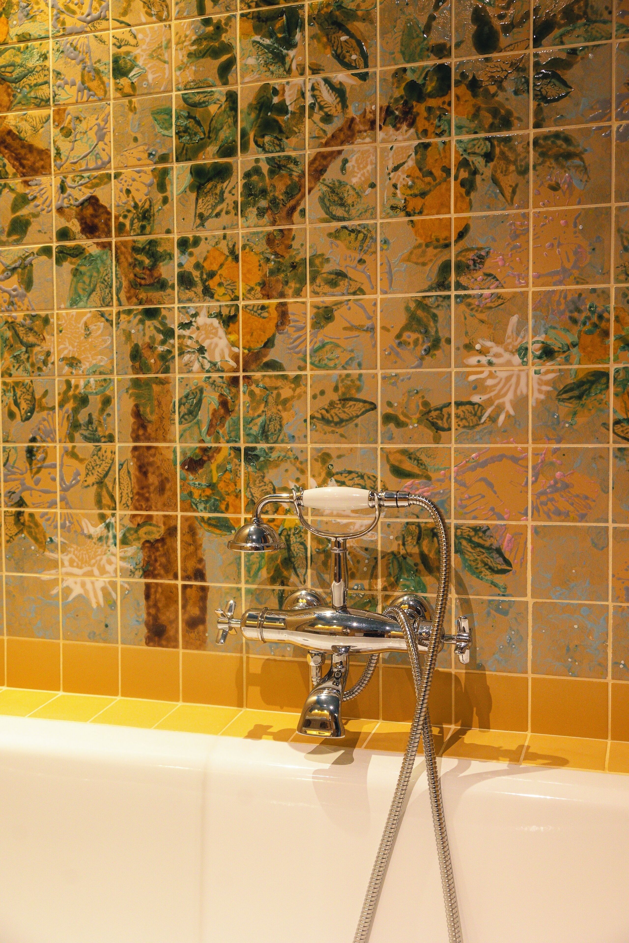 A bathtub with a showerhead and a handheld shower attachment.